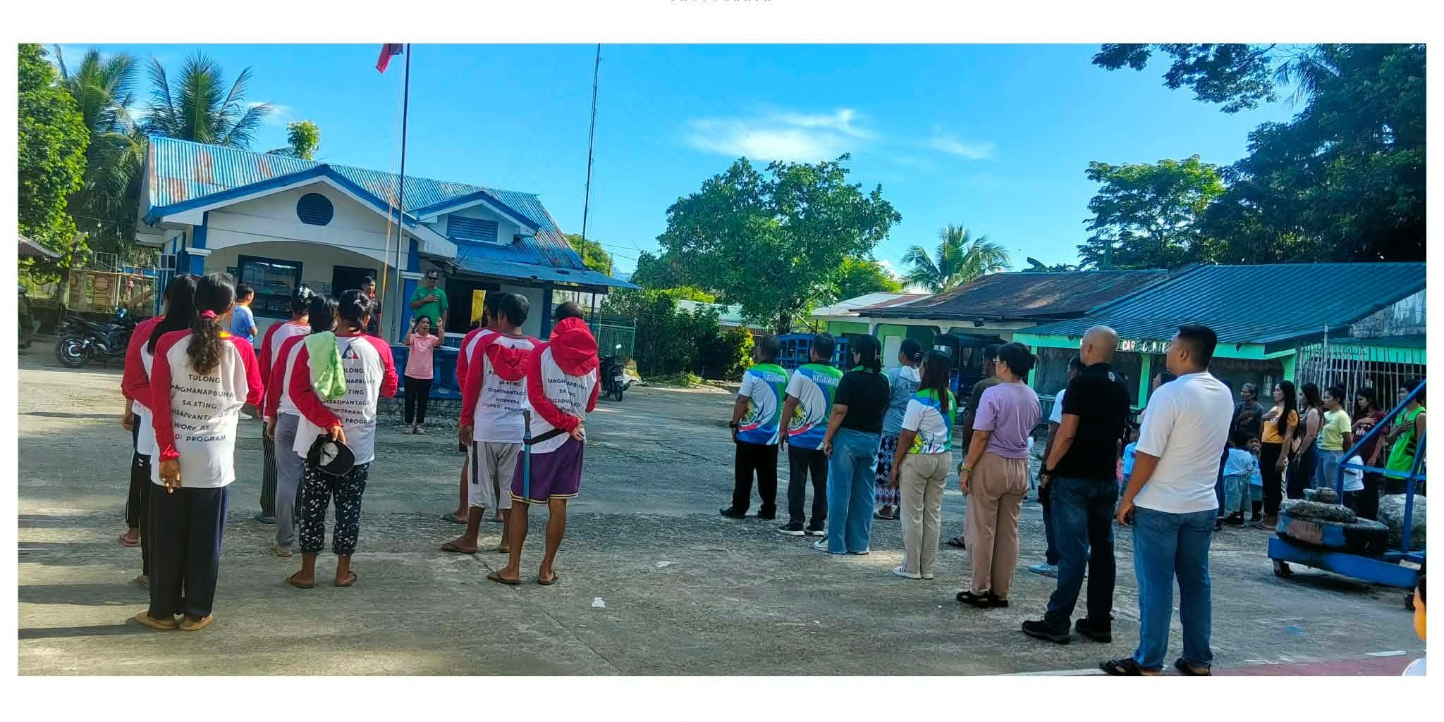 TUPAD workers in red caps at the municipal flag ceremony, Rizal, Occidental Mindoro